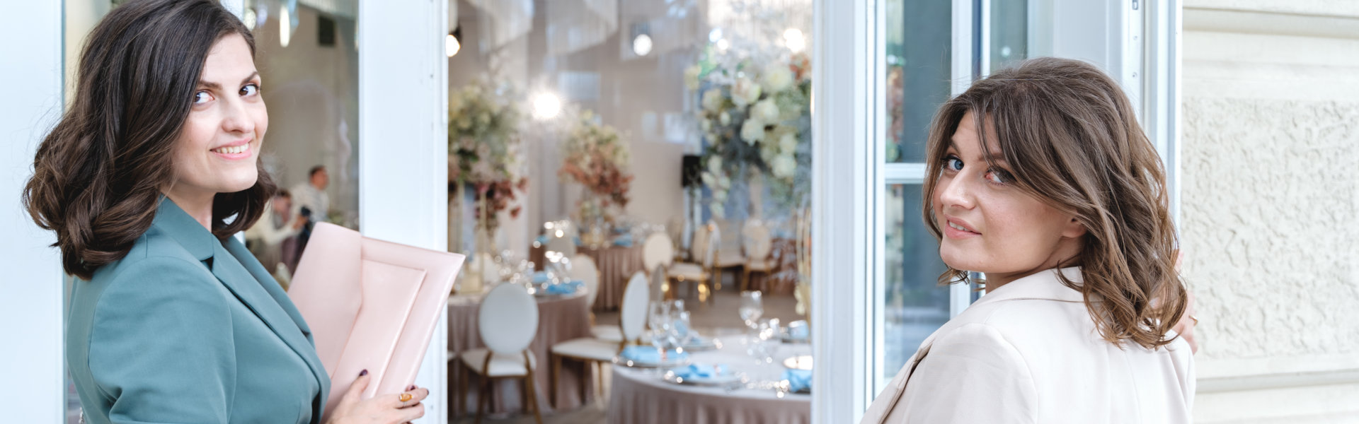 Young beautiful women, girls in stylish suits at entrance to restaurant. Business meeting, negotiations,signing contract with client,customer.